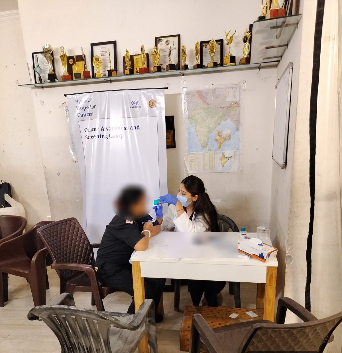 A clinician carrying out an oral examination at a Hope for Cancer camp in Gurugram, Haryana