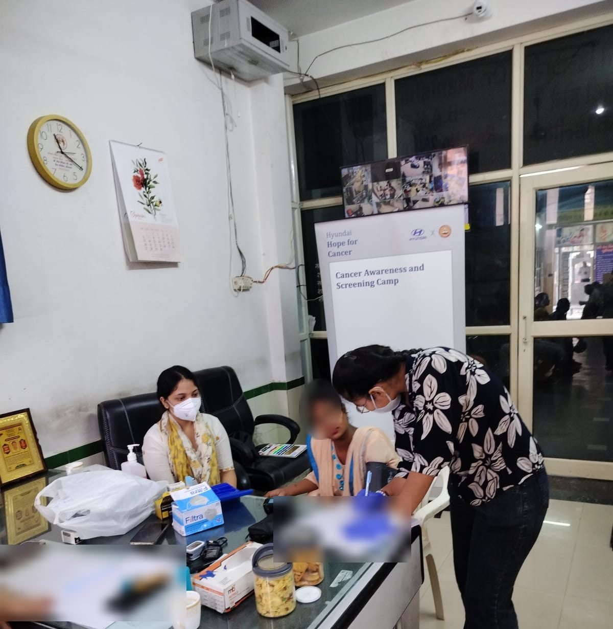 A health worker recording a blood-pressure check at a Hope for Cancer camp in Panipat, Haryana