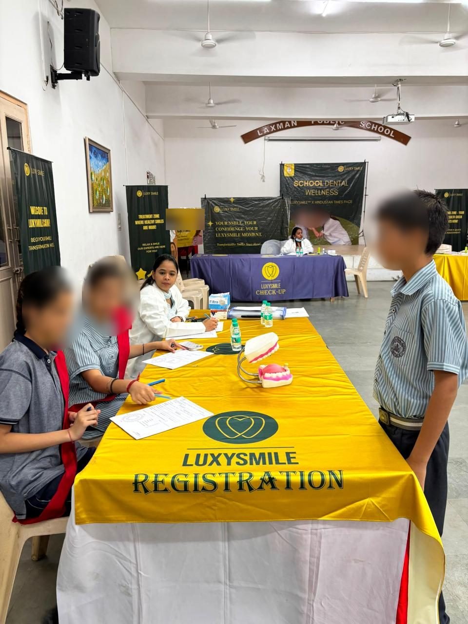 Students at the LuxySmile registration desk before screening