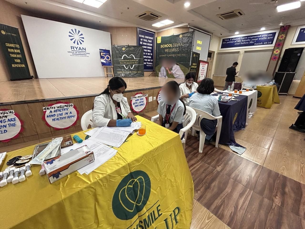 LuxySmile screening tables in a school auditorium in Delhi